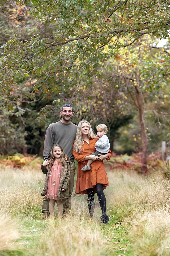 a family in an autumn woodland
